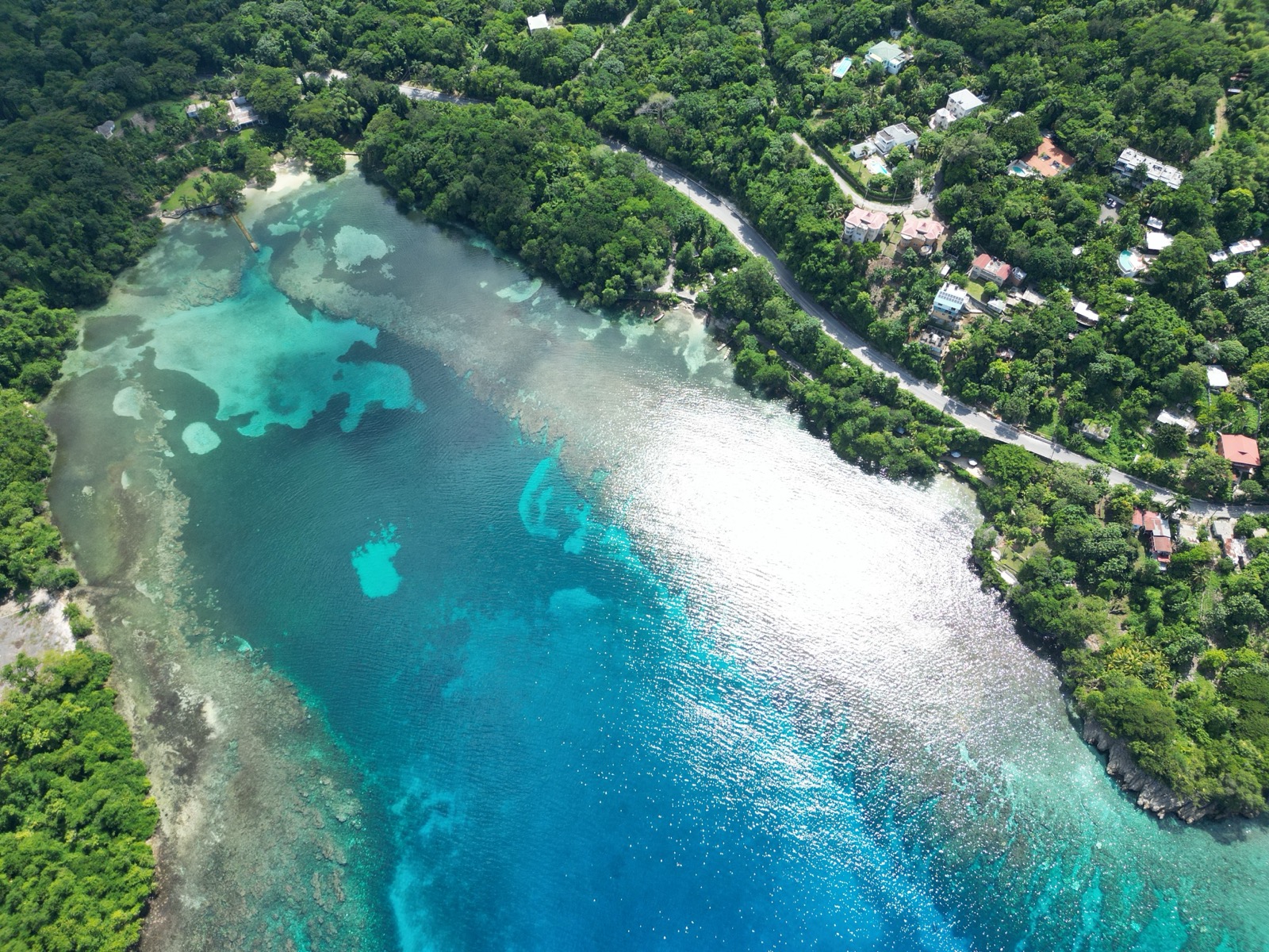 Aerial view of San San Beach's coral-protected turquoise lagoon