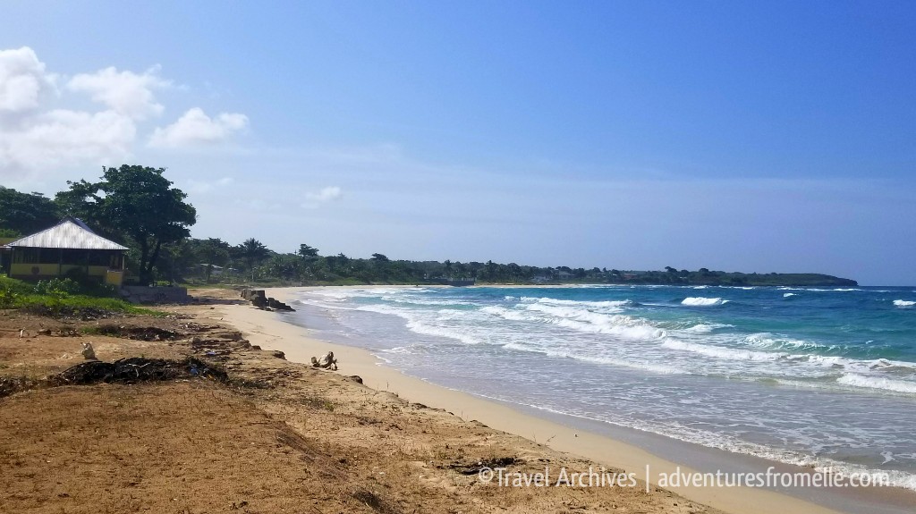 The long open stretch of Long Bay Beach with breaking surf (placeholder image — to be replaced)